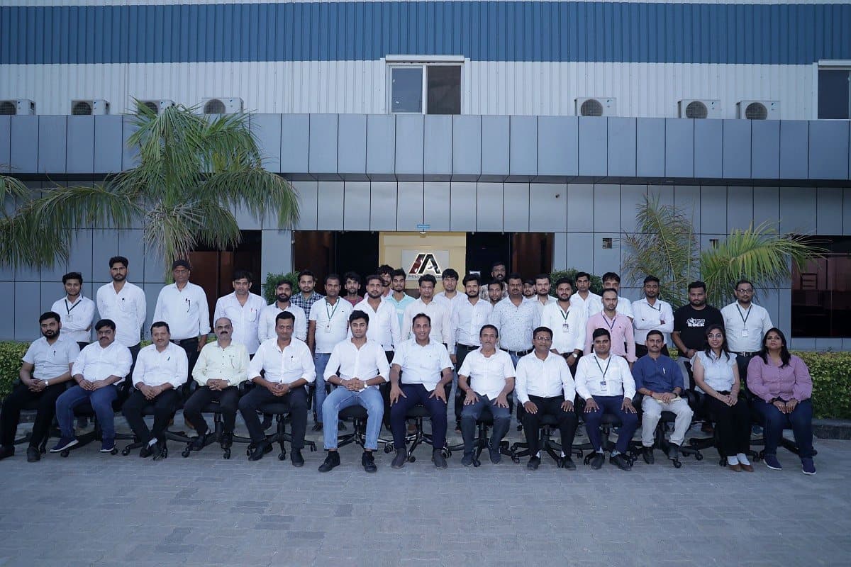 The Indus Appliances team seated and standing in front of the Bahadurgarh plant